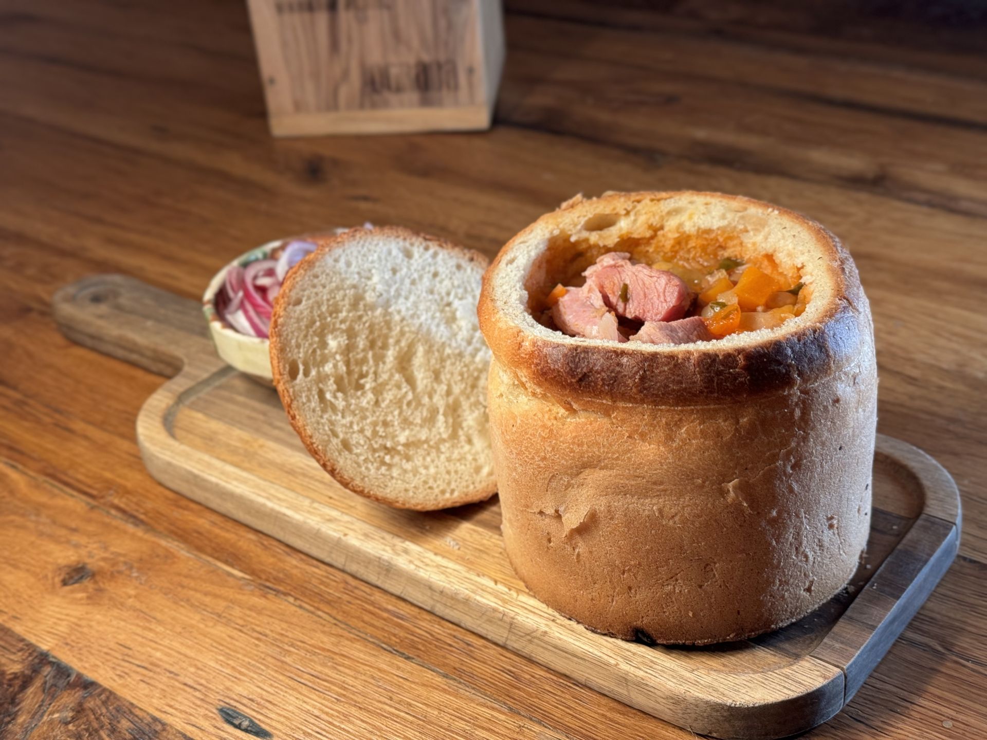 Bean soup with smoked ham served in bread